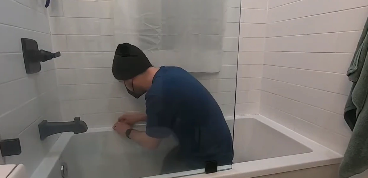 small repairs in Rochester NY: checking the sealant around a bathtub