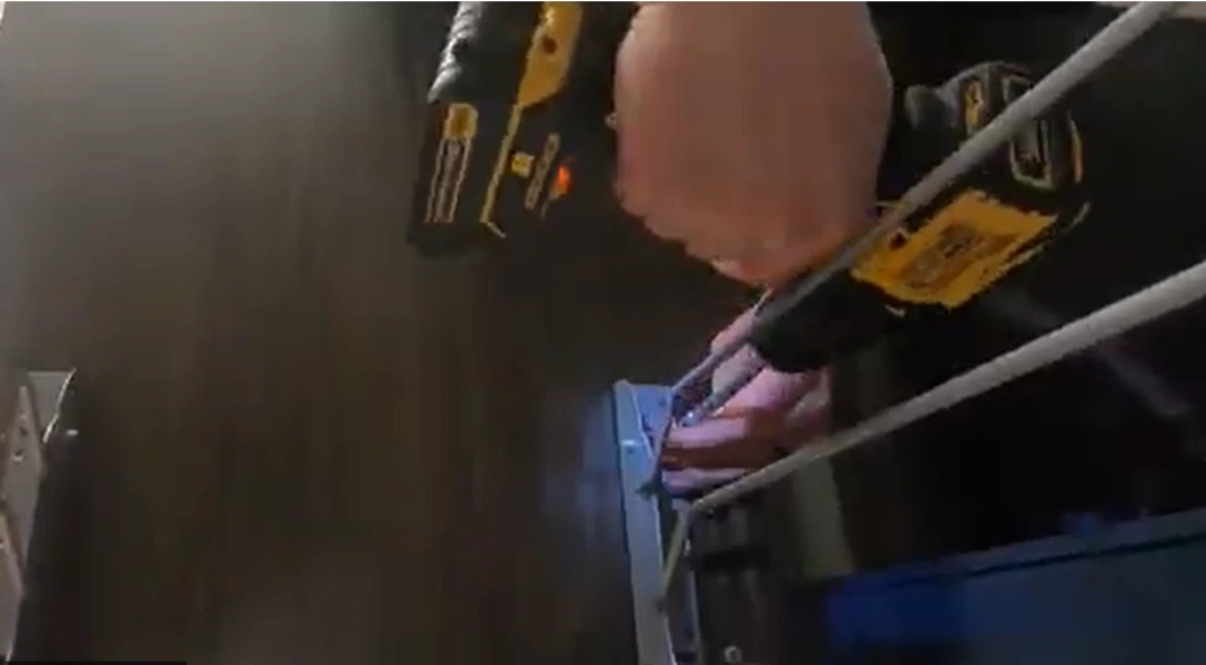 window repair in Rochester NY: cordless drill driving a screw into a frame